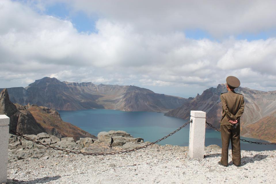  A North Korean solider looks over the active volcano, which experts warn is due to erupt