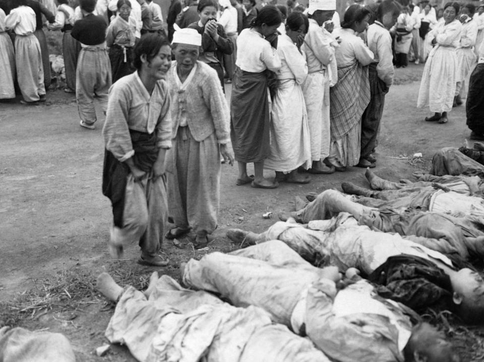  Civilians identify their loved ones killed during a battle