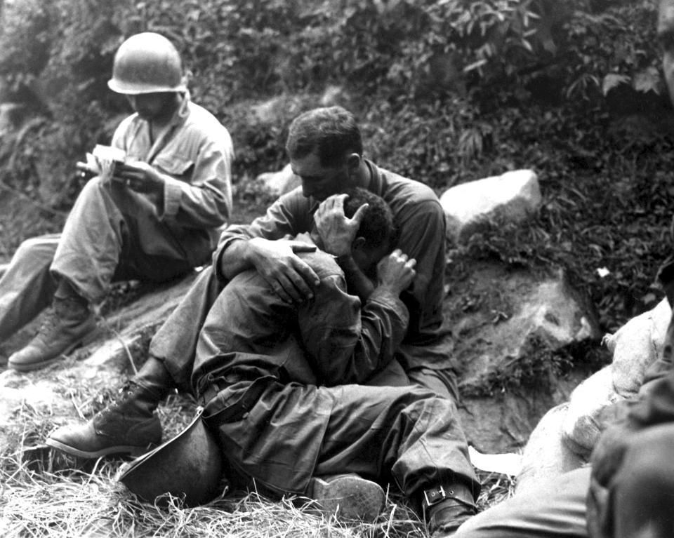  An American soldier comforts a fellow infantryman whose close friend has been killed in action, Haktong-ni area, Korea, August 1950