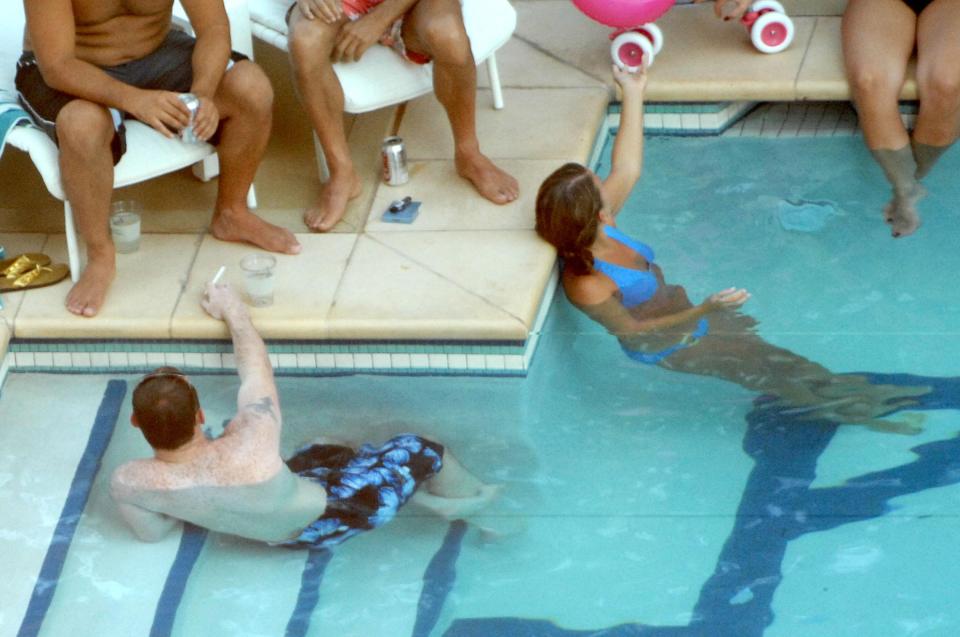  They're on the ball . . . Wayne and Coleen Rooney relax with friends in hotel swimming pool