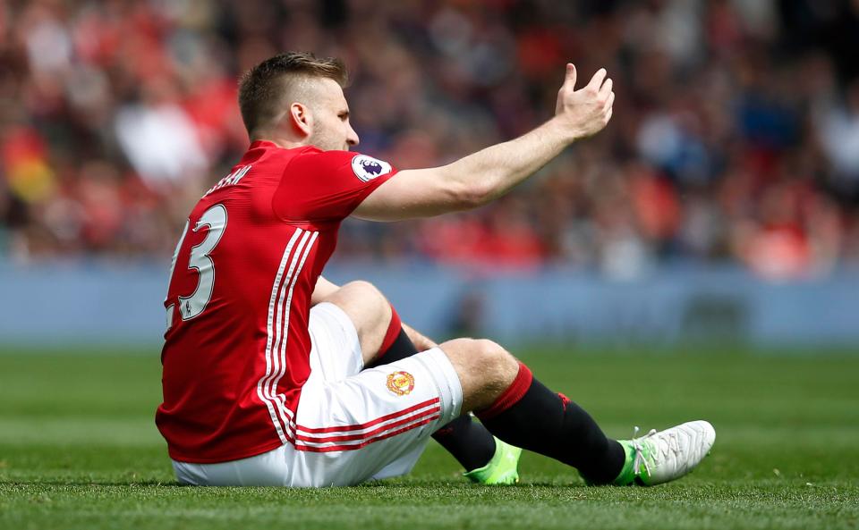  Luke Shaw sits down on the Old Trafford turn after holding his ankle