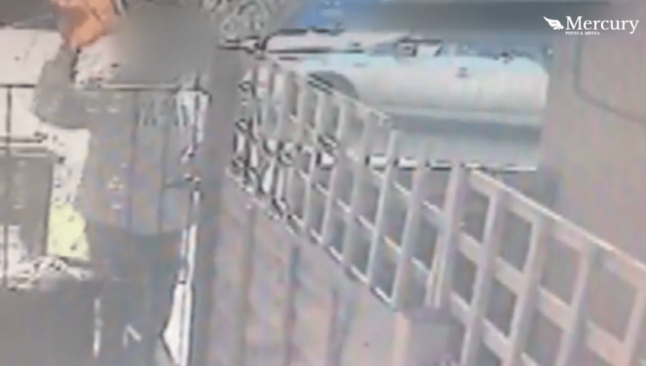  Craig's CCTV shows the courier pulling his arm back before shot-putting the package over the gate