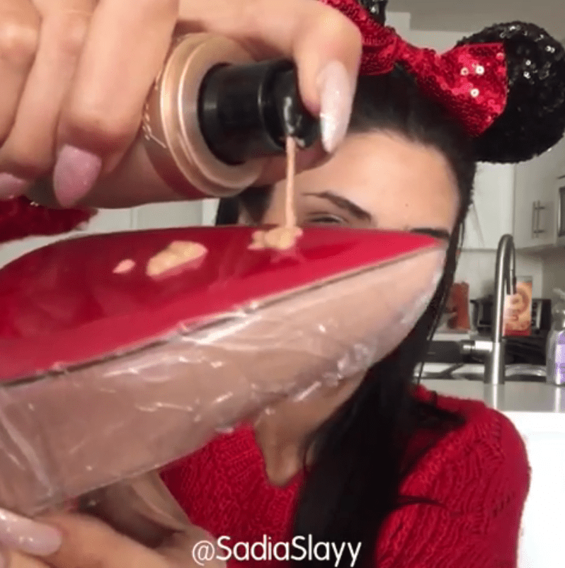  After covering the shoe with cling film the vlogger used the pointed sole to apply her foundation