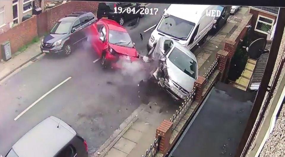  The car spins round and smashes into two cars on the other side of the street