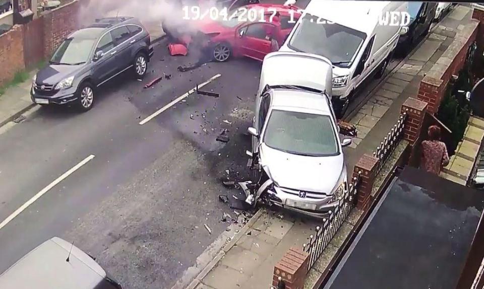  Three people - one carrying a dog - are shown getting out of the car