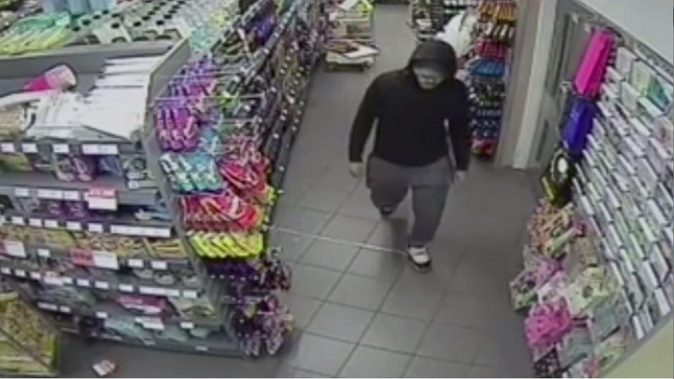  The man was pictured leaving the store with a carrier bag full of items