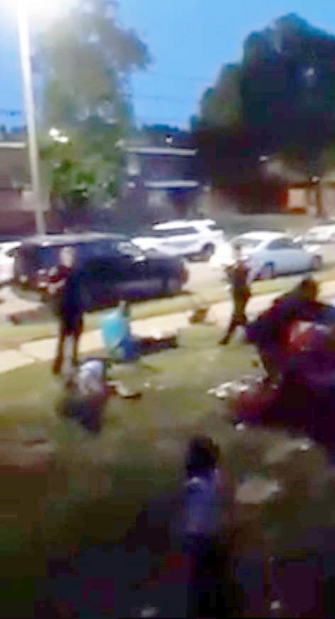  Footage shows one woman lying on the ground and another man, who appears to be handcuffed, in the aftermath of the incident