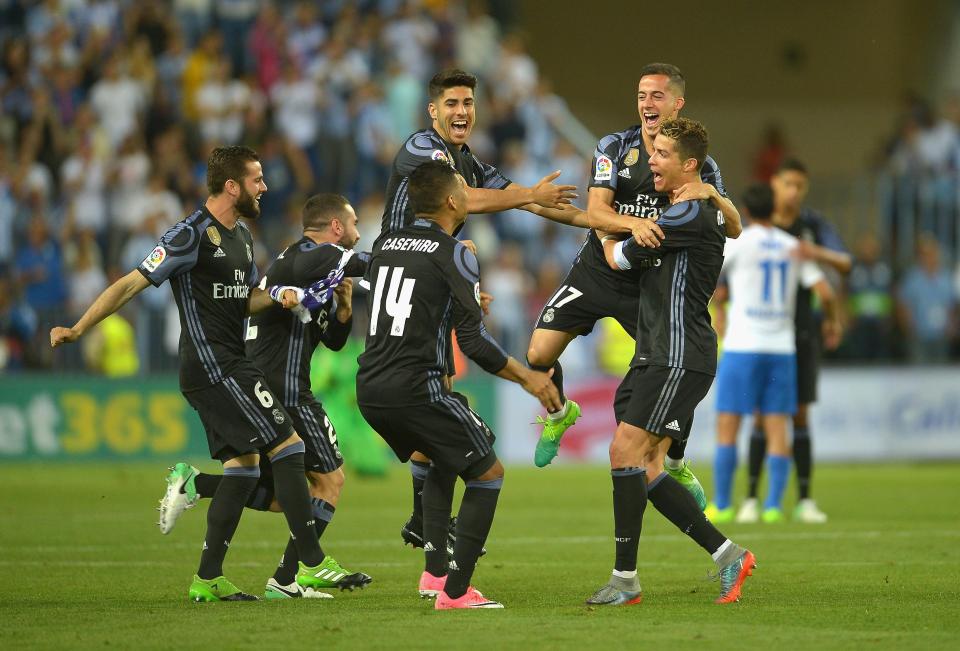 Real Madrid's players celebrate the winning moment at Malaga