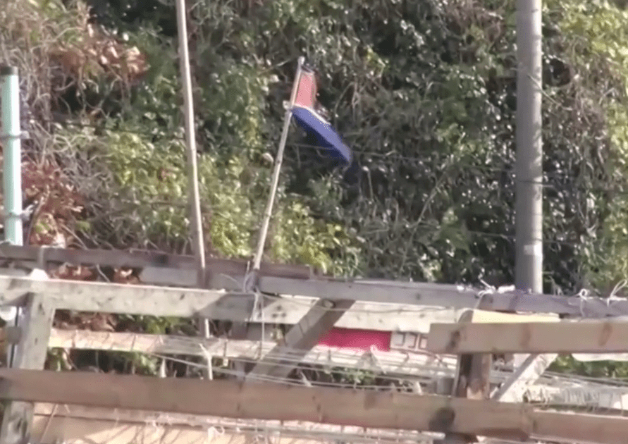  A tattered North Korean flag flutters from a pole on one of the doomed boats