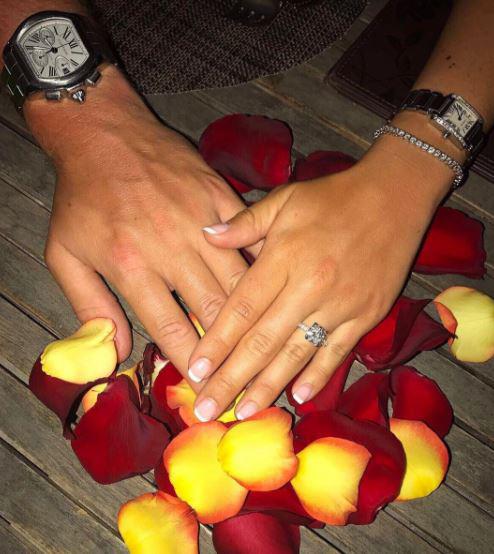  The newly engaged couple posted matching photos showing off the sparkling diamond ring