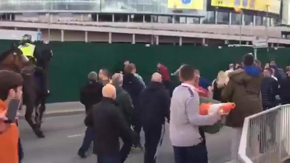  One man decides to arm himself with a traffic cone as the fighting gets out of hand