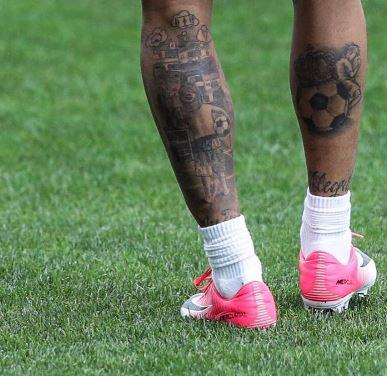  Neymar's calf shows a big tattoo of him as a boy and an industrial scene - to remind him of where he came from