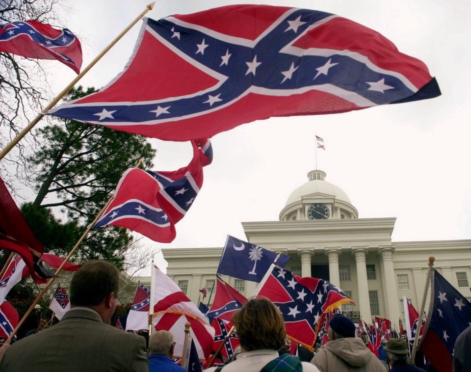  Protesters fly the confederate flag as they call for the notorious symbol to be reinstated to the top of the Capitol building in Montgomery, Alabama