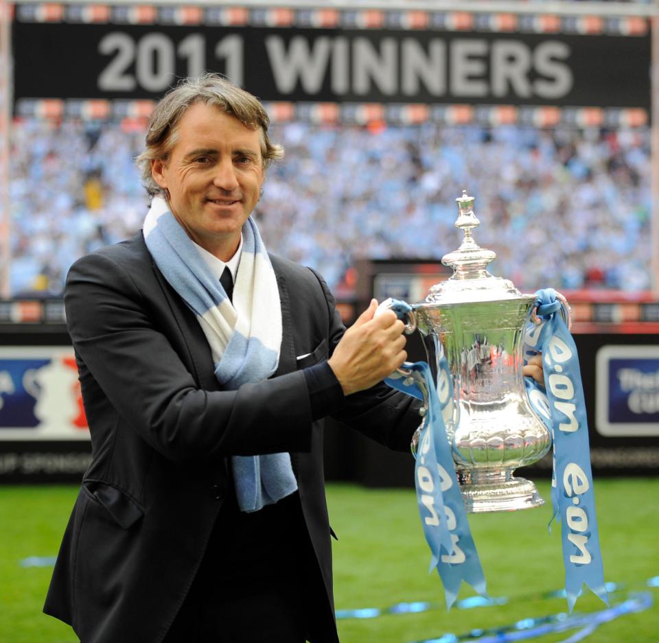  Roberto Mancini celebrates winning the FA Cup with Manchester City in 2011