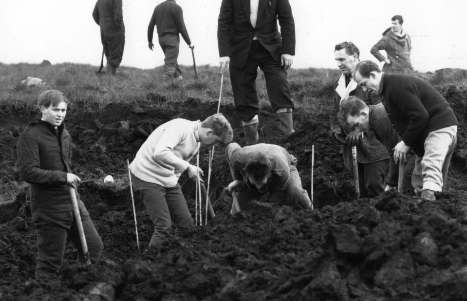 Policemen digging at the scene where the body of Moors murder victim Lesley Downey was found