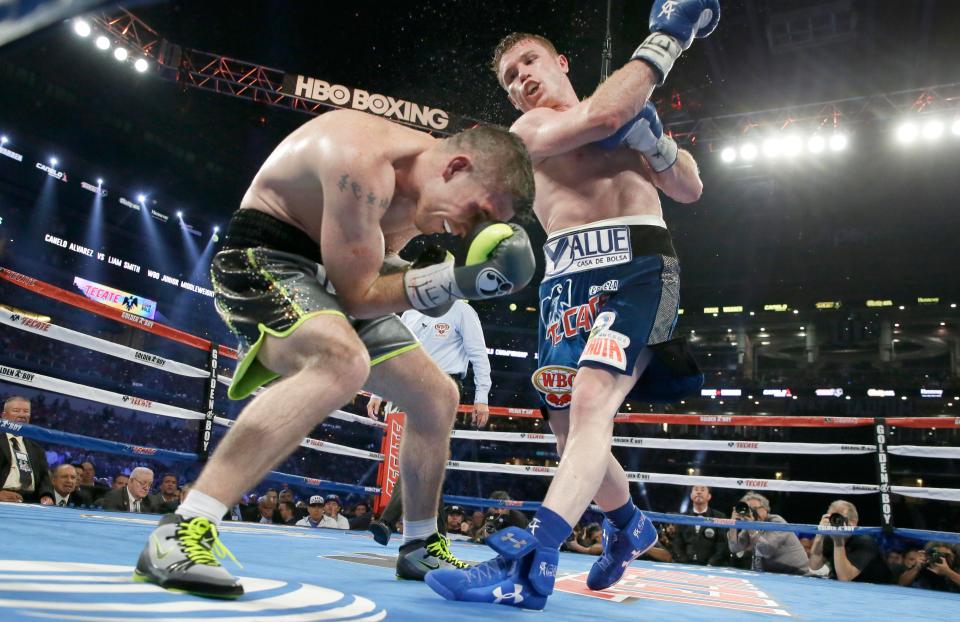  Canelo Alvarez punches Liam Smith during the eight round of the WBO Junior Middleweight title fight in Arlington, Texas in 2016