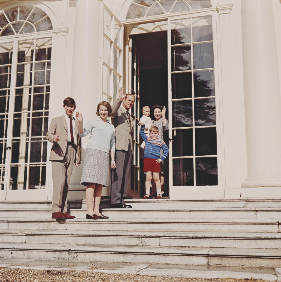  Cheery salutes from the Queen, holding a young Prince Edward, husband Philip, Prince Andrew, Prince Charles and Princess Anne from the steps of royal retreat Frogmore House in Windsor in April 1965