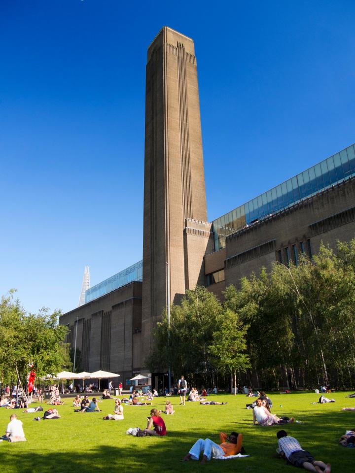  Londoners bask in the sunshine in front of the Tate Modern at Bankside