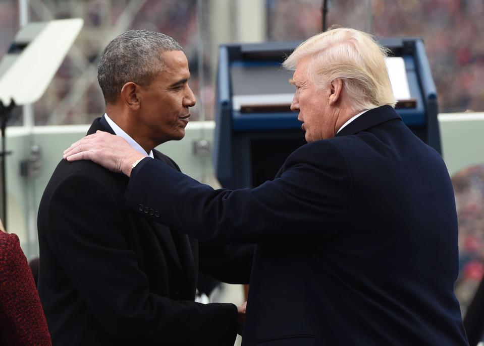 Trump places his hand on Obama's shoulder as he prepares to move in to the White House 