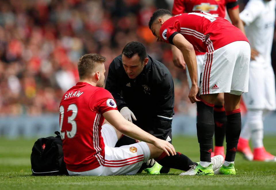  Luke Shaw is examined on the pitch at Old Trafford as Jesse Lingard shows his concern