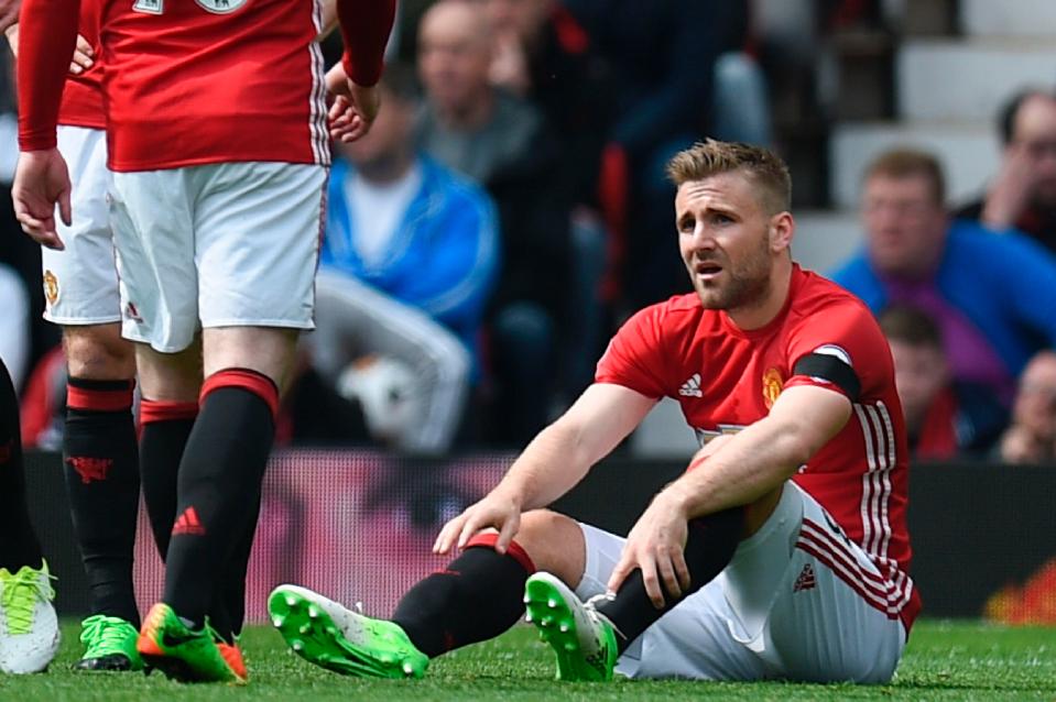  Luke Shaw slumps to the ground early during the clash with Manchester United