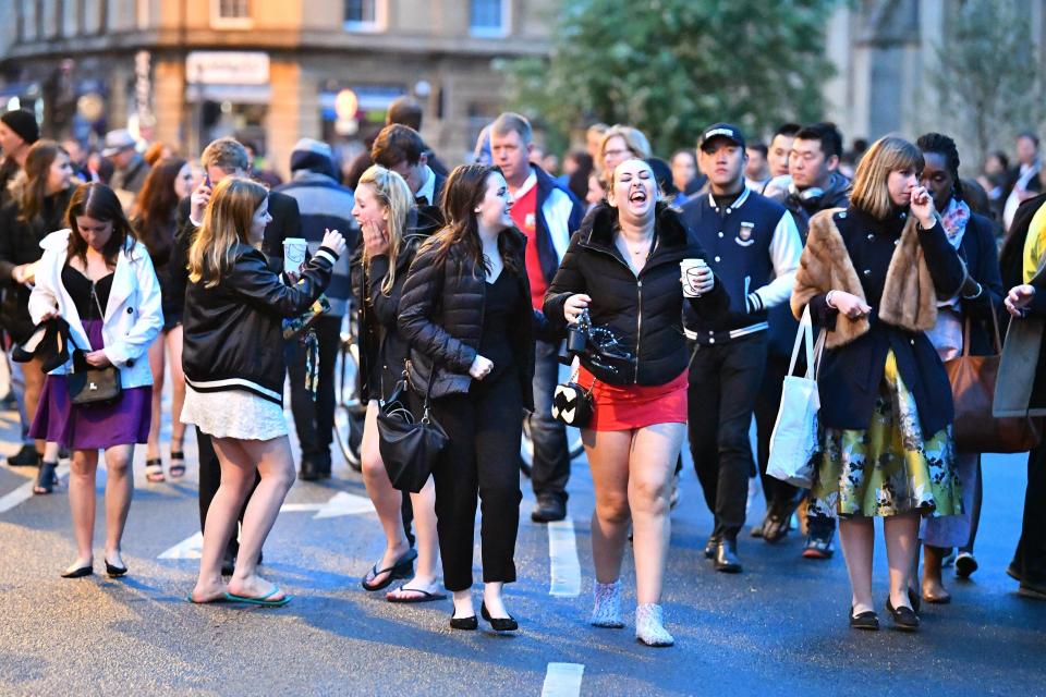  Party-goers cling to much-needed coffee as they power through to this morning's May Day celebrations