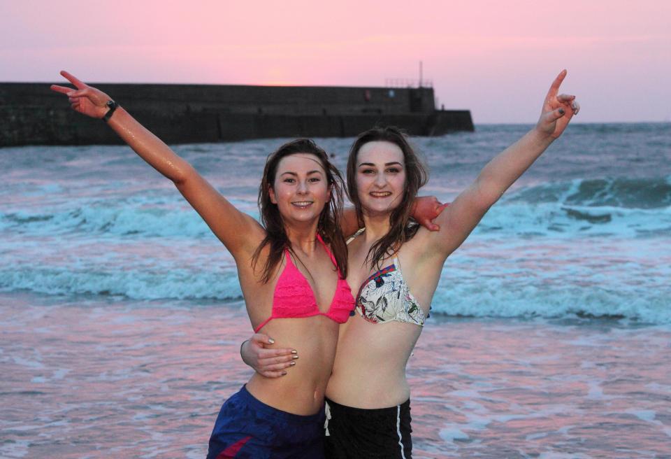  Two friends celebrate after completing the May Dip in St Andrews, fabled to bring good luck in exams