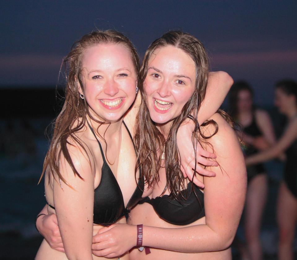  Two girls are still smiling after dunking themselves in the freezing North Sea