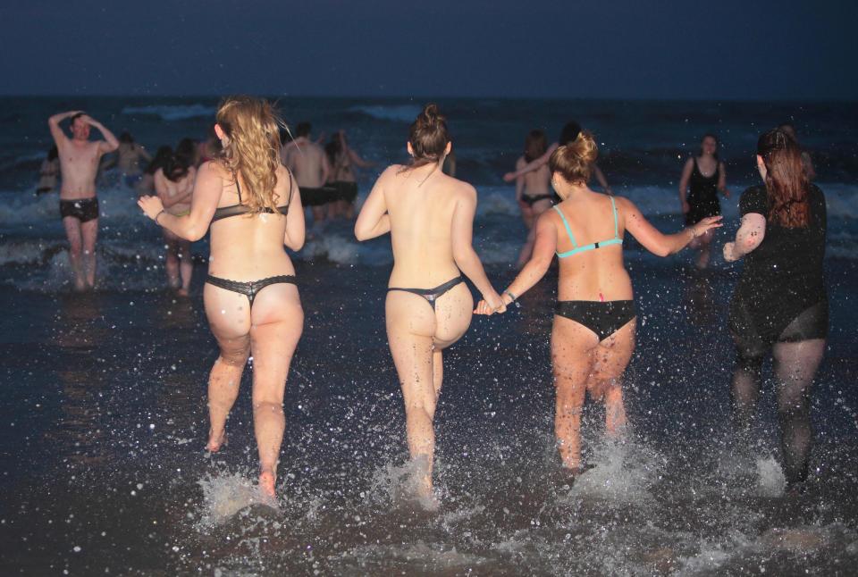  Cheeky students strip off and run into the sea during all-night celebrations at St Andrews