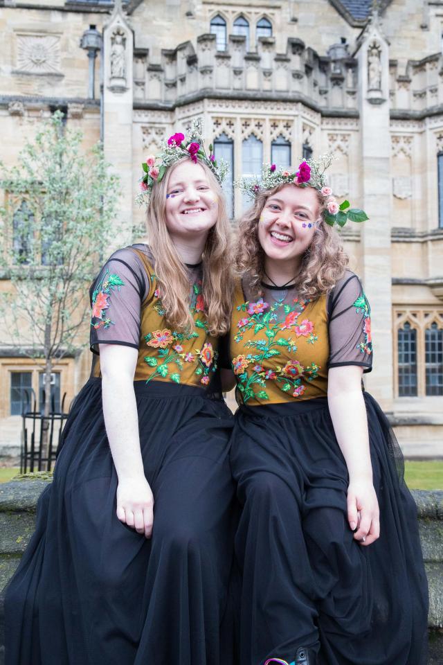  Two performers channel nature with flowers in their hair and painted on their cheeks