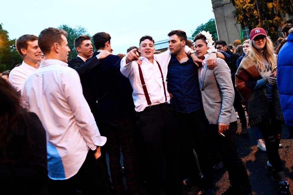  A man in braces looks to be in high spirits amid dawn celebrations in Oxford