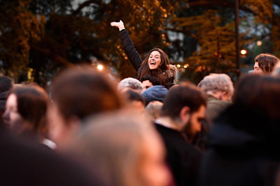  A woman waves across the crowd during Oxford's May Day