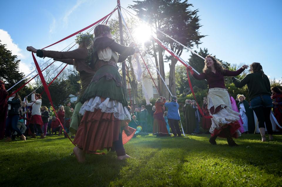  Revellers take part in a traditional May pole dance at Chalice Well, Glastonbury