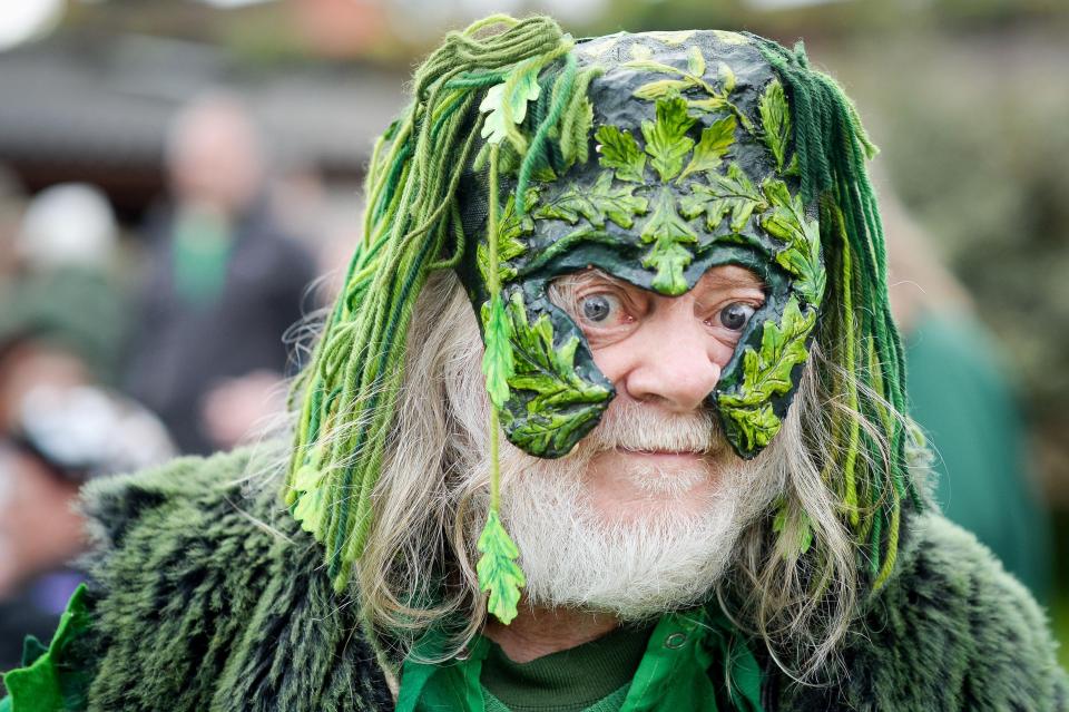  A man in fancy dress takes part in celebrations in Glastonbury