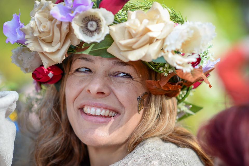  A woman wears a flower headdress during May Day celebrations in Glastonbury