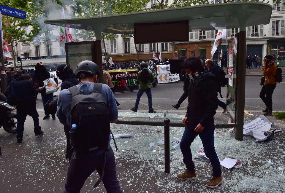  Demonstrators rampage through the city, smashing up a bus stop as they fight pitch battles with police