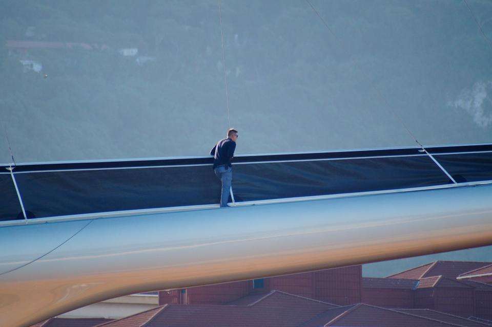  A man can be seen walking across one of the vessel's enormous 'booms'