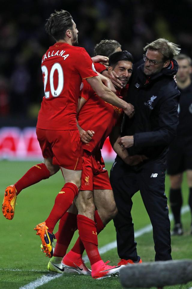  Emre Can is quite rightly mobbed by his team-mates and manager Jurgen Klopp after scoring a worldie