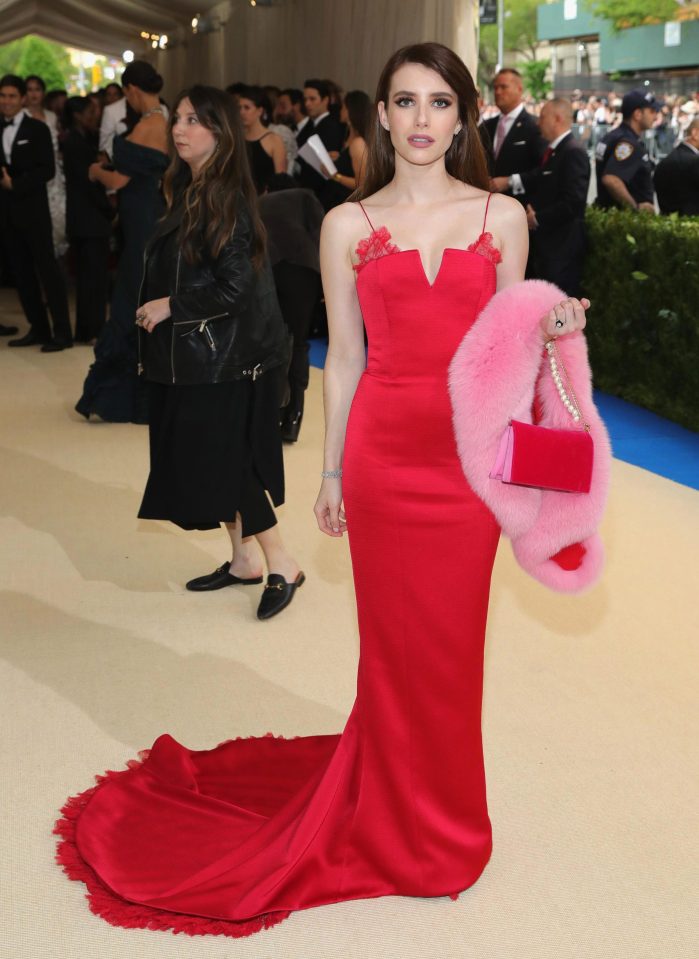  Emma Roberts teamed her scarlet gown with a pink, faux fur stole