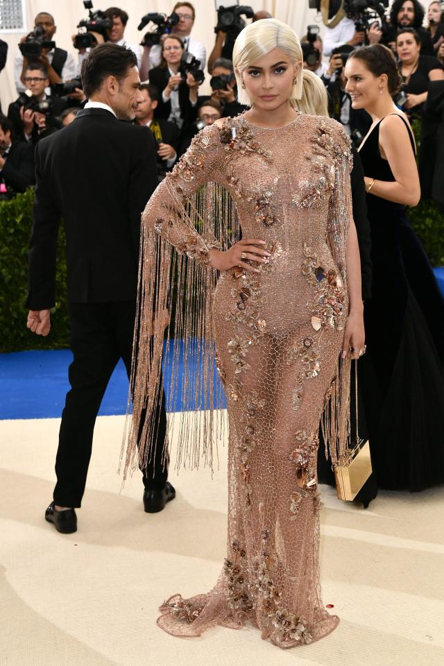  Kylie Jenner wore a show-stopping nude Versace gown adorned with gold flowers and tassels