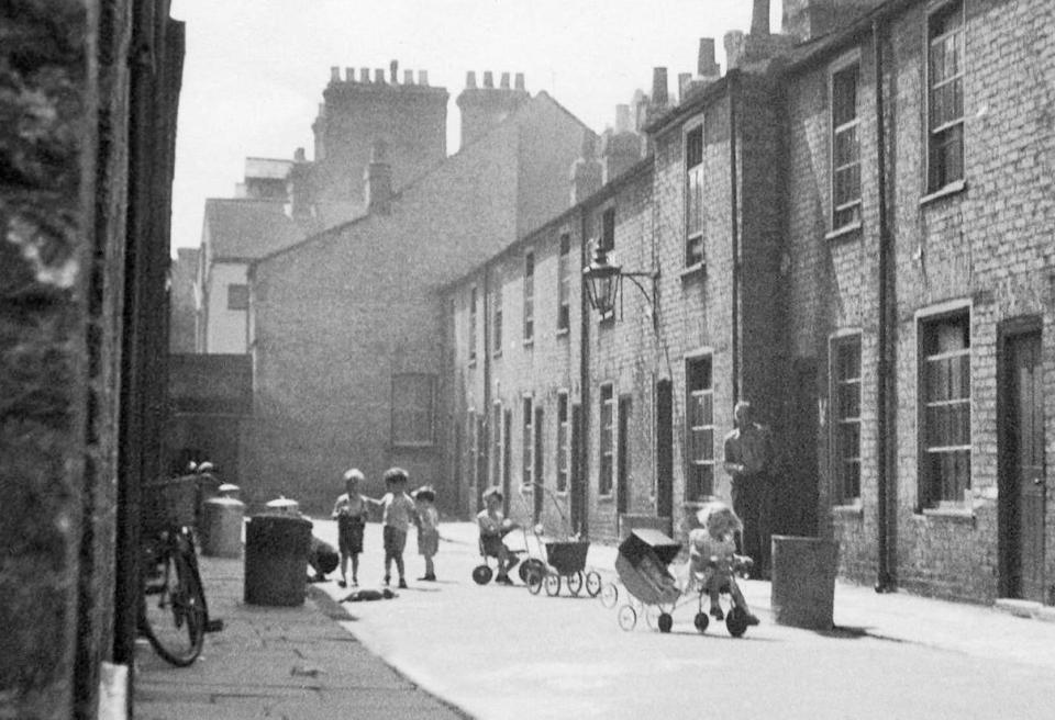  Children would gather in the streets in the summer to play with plays and toy prams. Pictured is Gothic Street in Cambridge