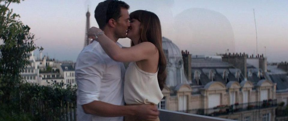  Christian and Anastasia (Dakota Johnson) smooch in front of the Eiffel Tower