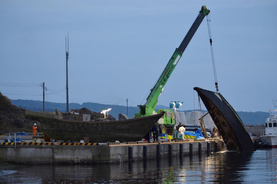  A wooden boat is salvaged in Wajima, central Japan, on November 21, 2015