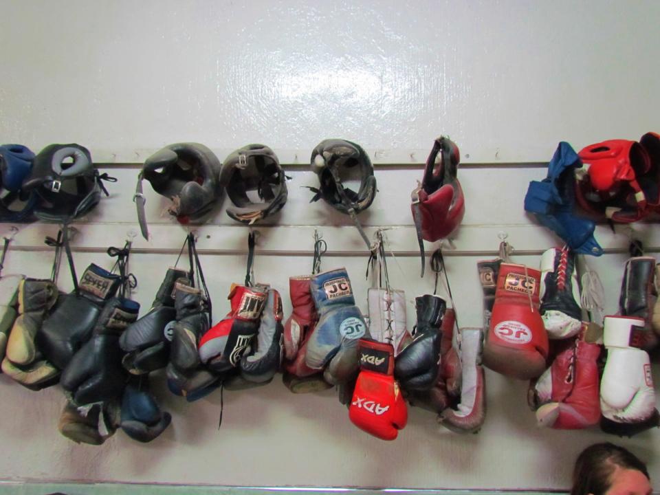  Rows of boxing gloves and head protectors in the gym where Saul 'Canelo' Alvarez turned his anger into boxing talent