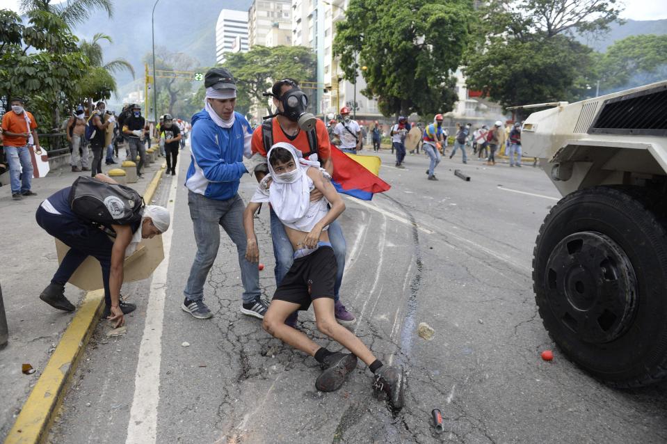  An injured demonstrator is dragged away in the latest violent protest against the president