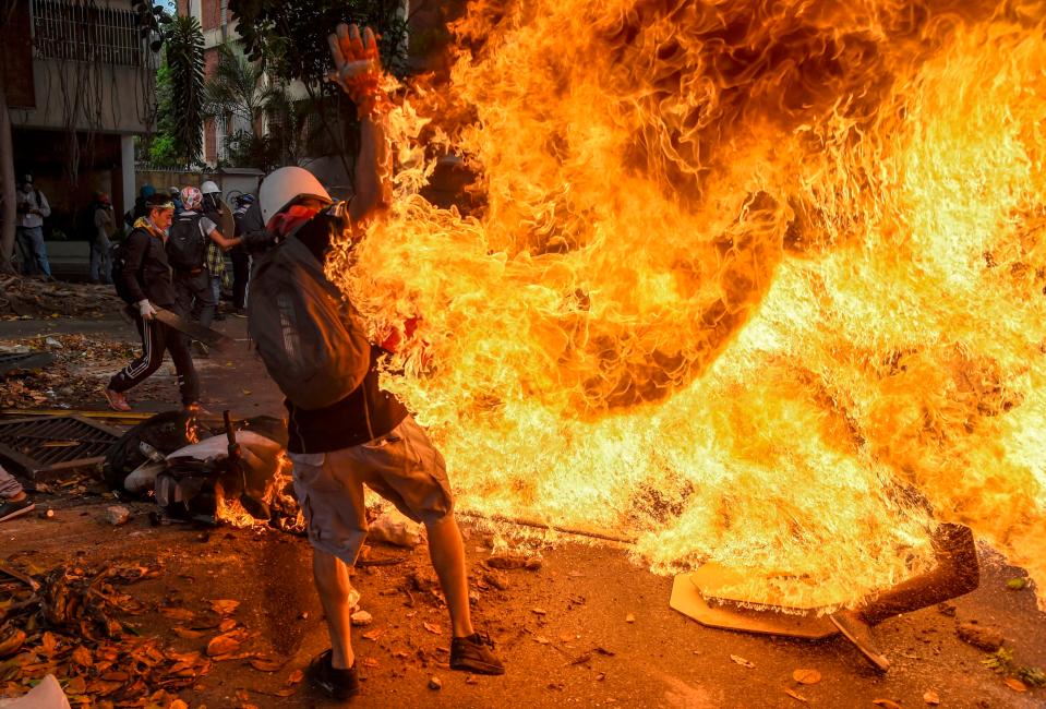  Incredible pictures show the moment a fireball engulfed the protester, setting his clothes alight