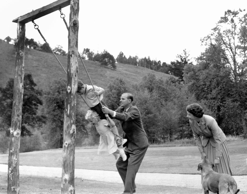  A young Charles and Anne being pushed on a swing by their father Prince Philip in the grounds of Balmoral in the 1950s