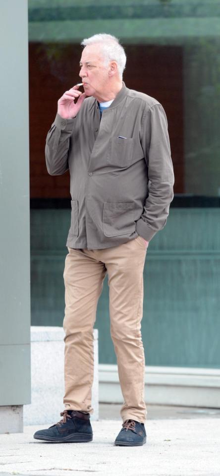  Michael Barrymore cuts a lonely figure as he puffs on a cigarette while waiting for a London bus