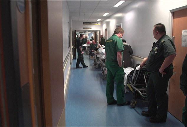  People lying on trolleys in the corridors of an overcrowded hospital