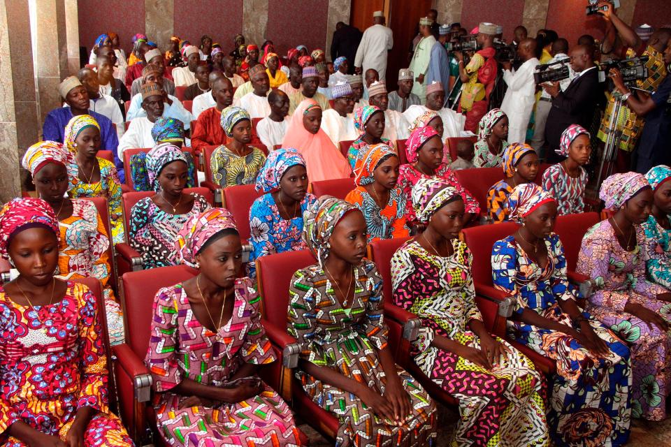  This file photo from October 19, 2016 shows 21 Chibok girls who were released a week before, attending a meeting with the Nigerian President